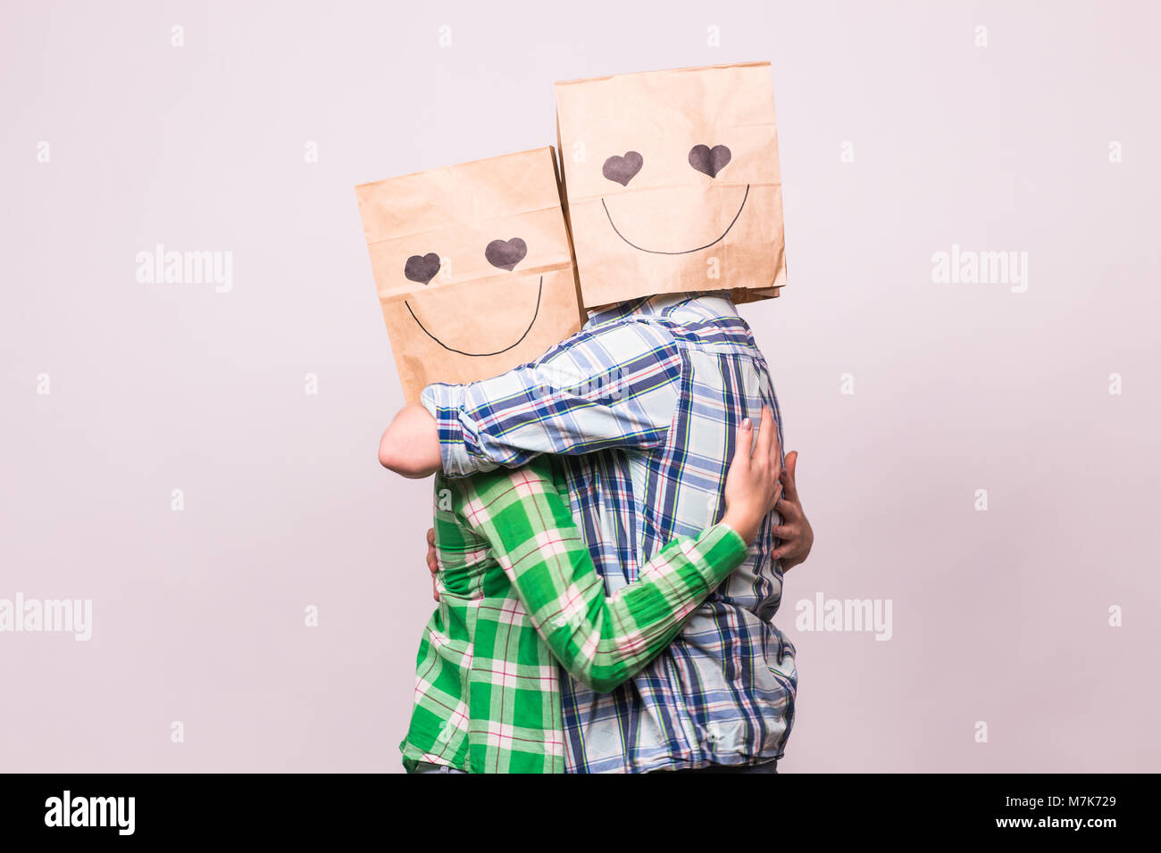 valentine-s-day-concept-young-love-couple-with-bags-over-heads-on