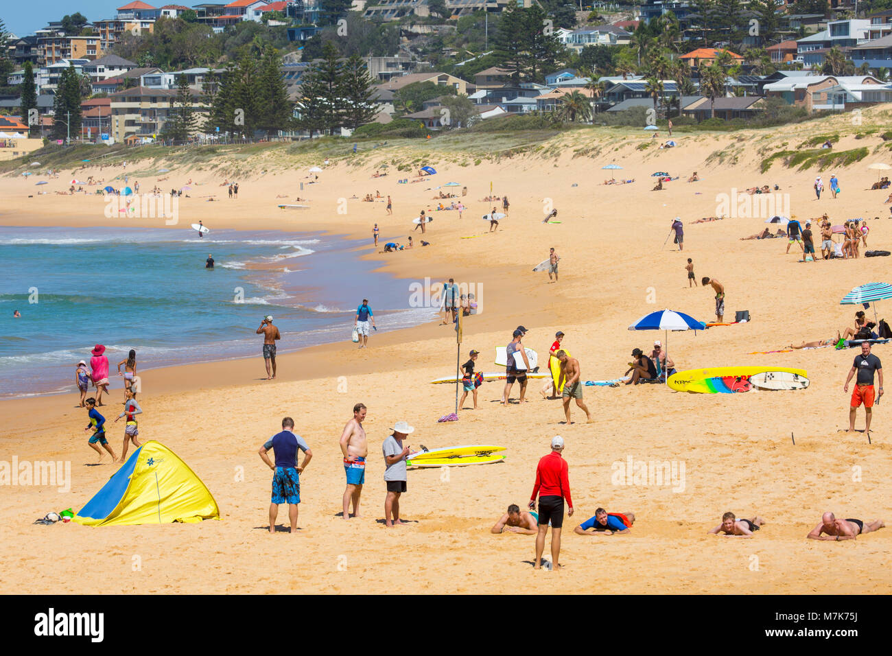 People enjoying warm autumn day on North Curl curl beach looking towards south curl curl beach,Sydney,Australia Stock Photo