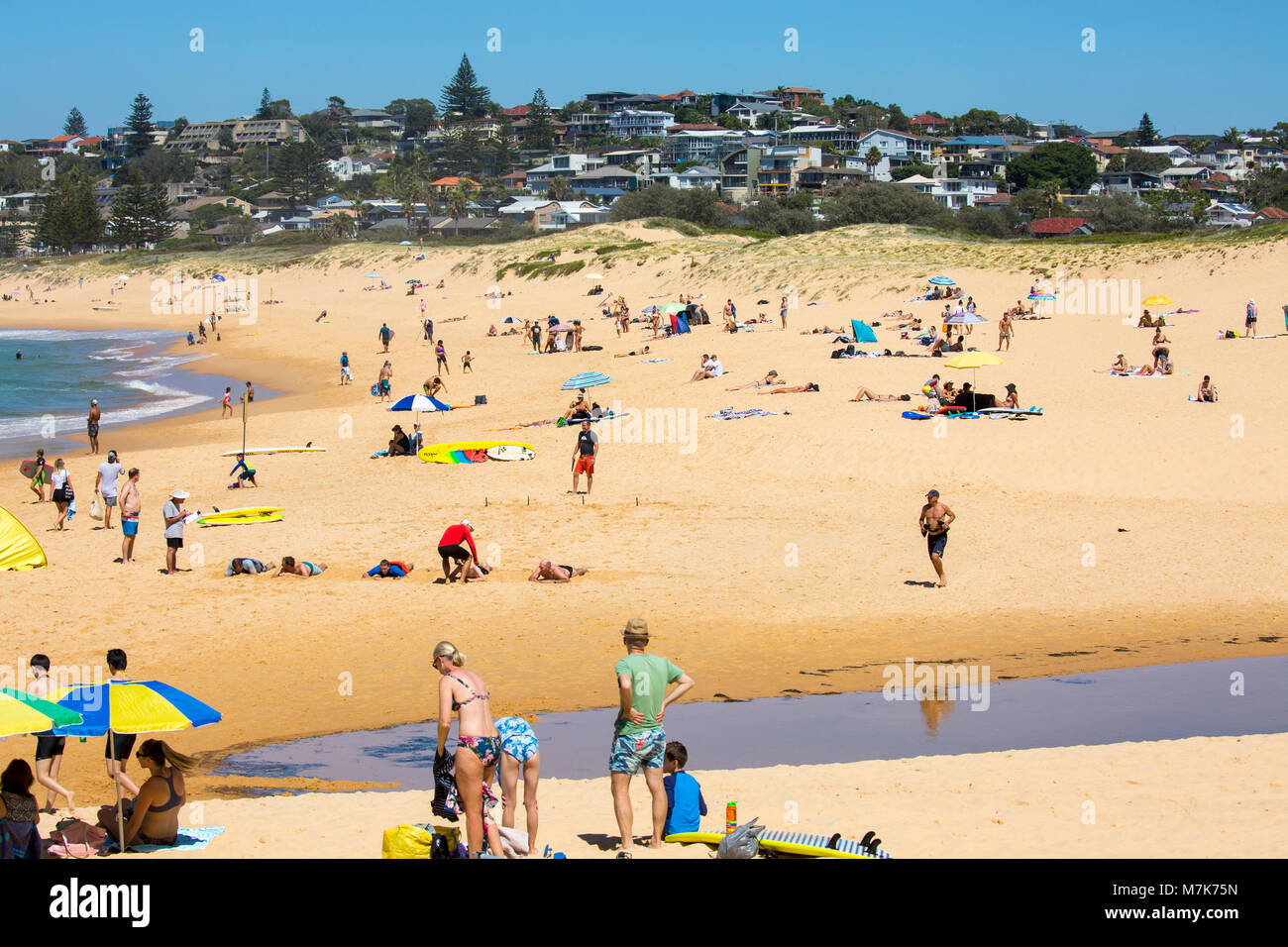 People playing on North Curl Curl beach and looking towards south curl curl beach,Sydney,Australia Stock Photo