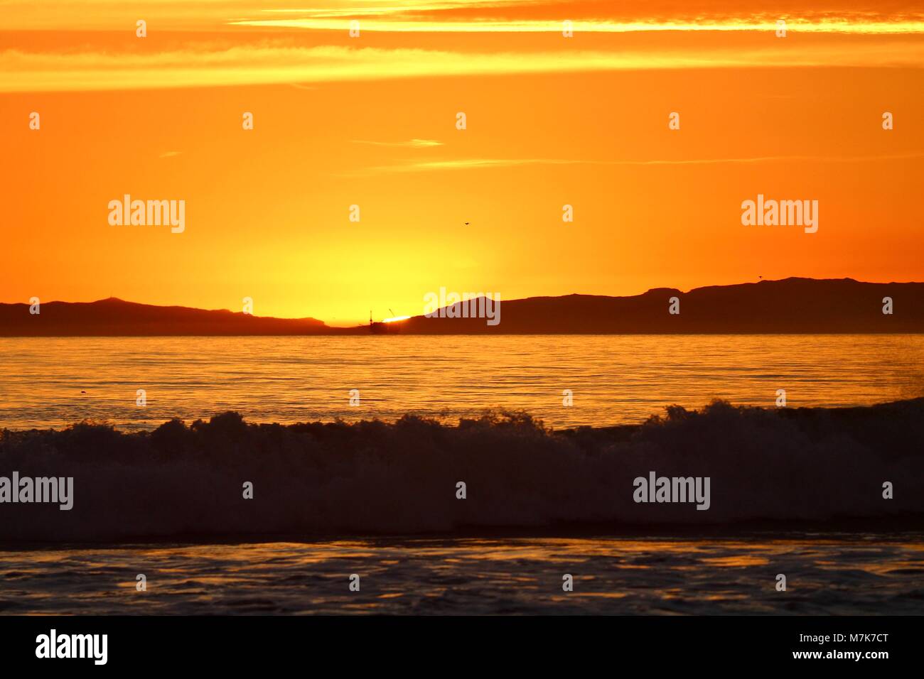 Orange sunset off the coast of California Stock Photo