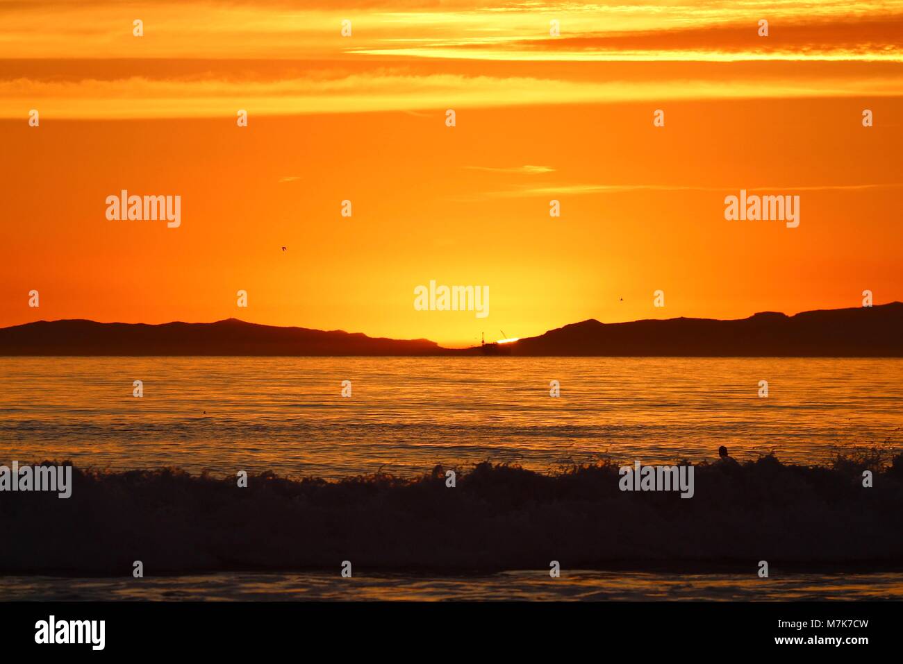 Orange sunset off the coast of California Stock Photo