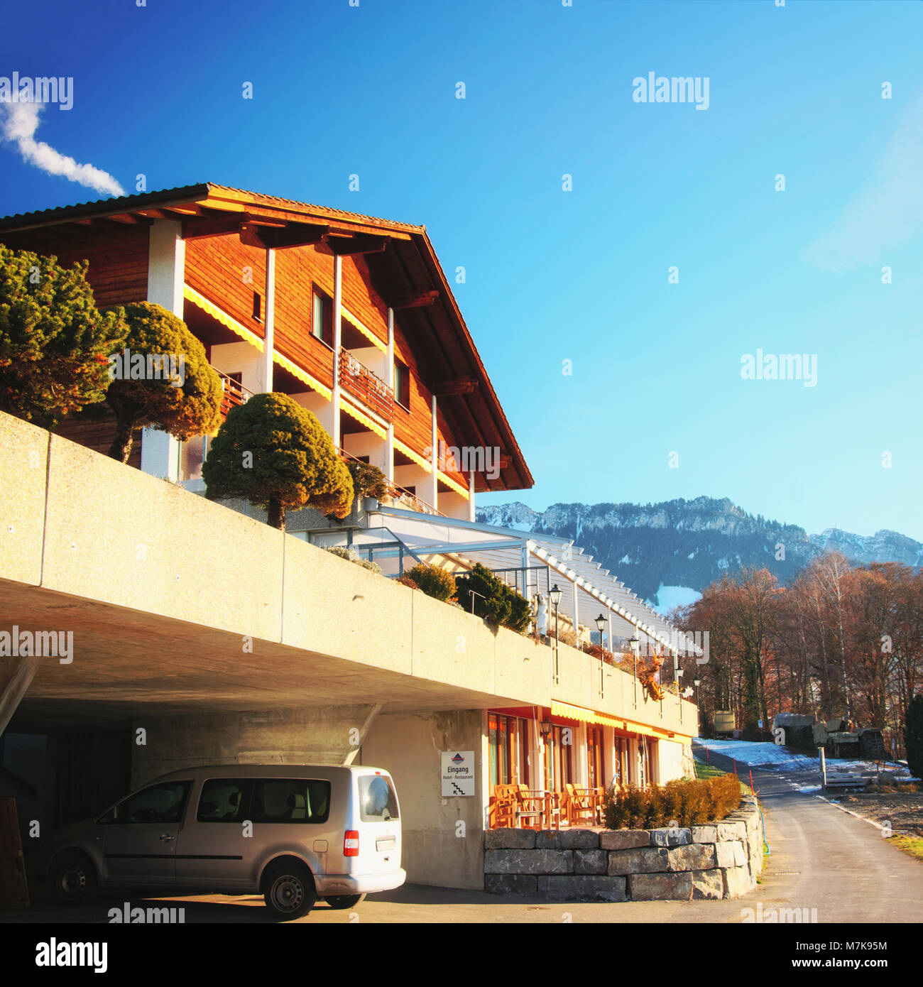 Sigriswil, Switzerland - December 31, 2013: Building with garage placed at Swiss Alps mountains and Thun lake, Switzerland in winter Stock Photo