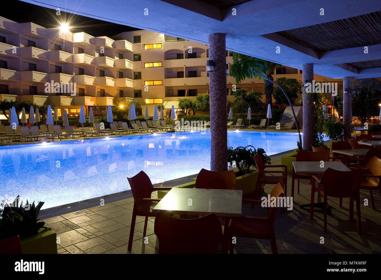 IALYSSOS, GREECE - MAY 03: Cafe and illuminated swimming pool of Ialyssos Bay Hotel during night time on May 03, 2016 in Ialyssos, Greece Stock Photo