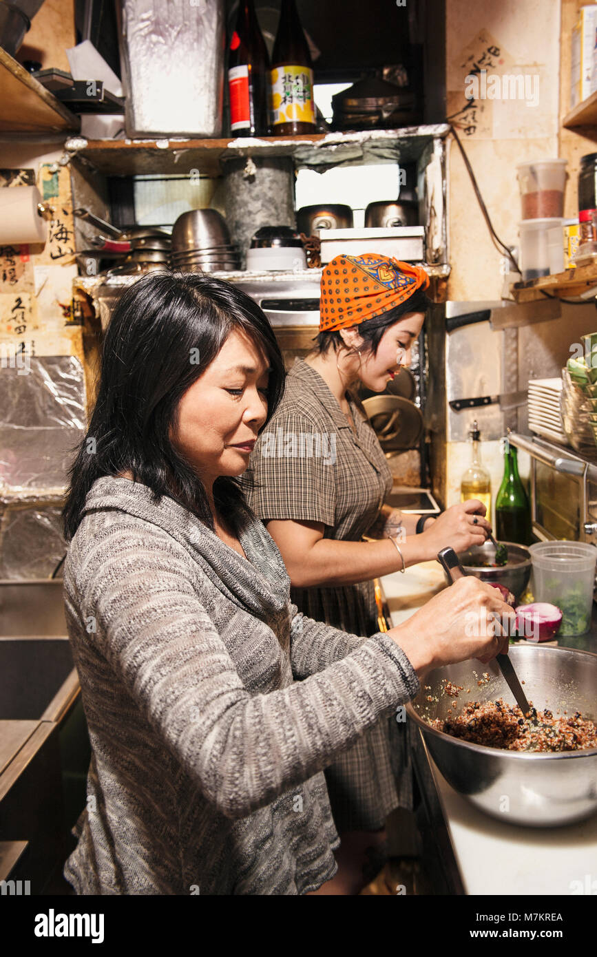 A mother and daughter cooking in a restaurant kitchen in New York City Stock Photo Alamy