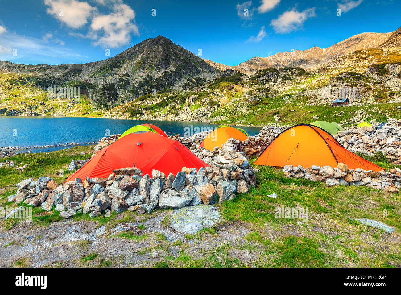 Wonderful alpine camping place with colorful tents near Bucura glacier ...