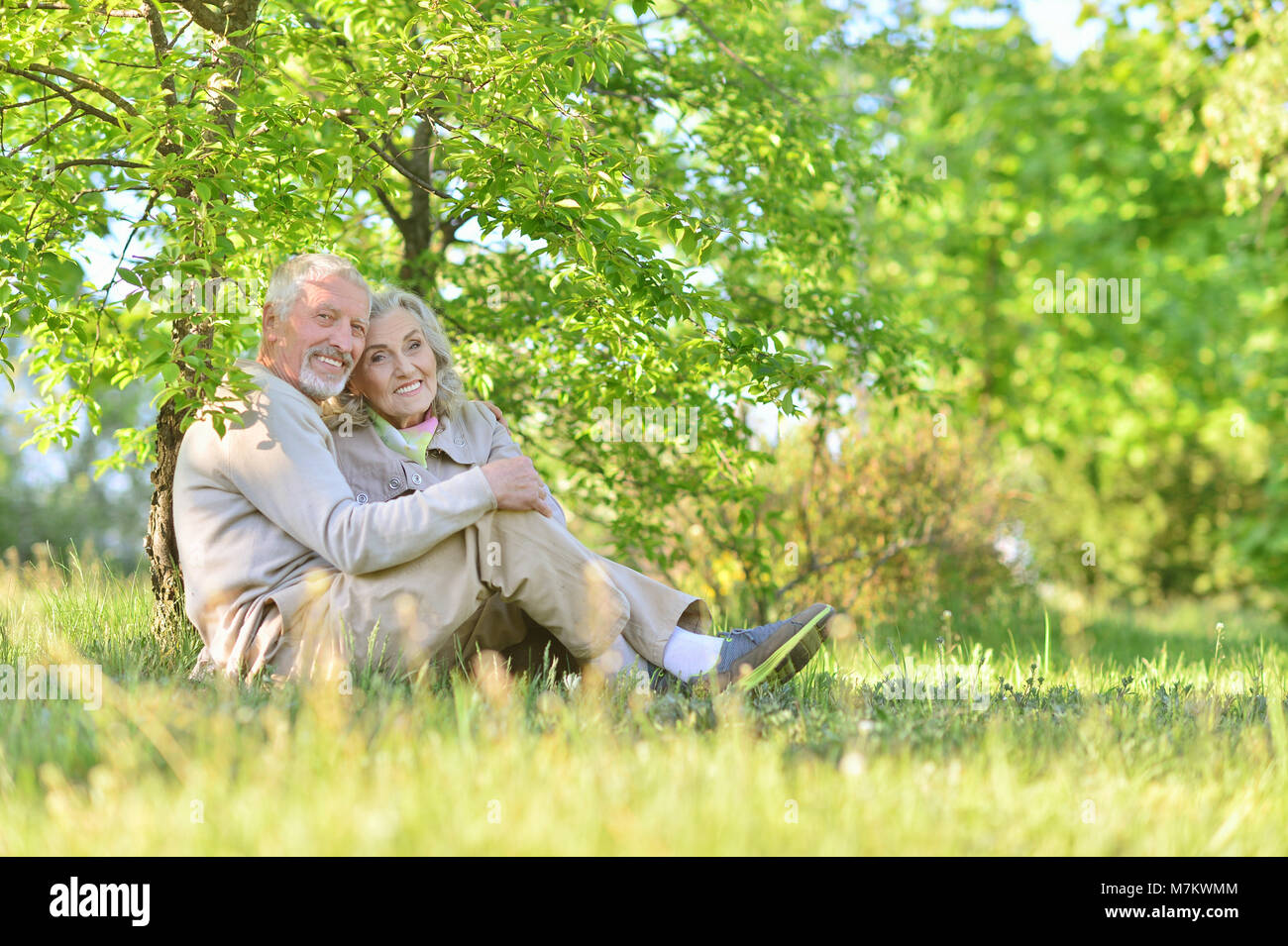 Happy couple hugging in spring park Stock Photo - Alamy