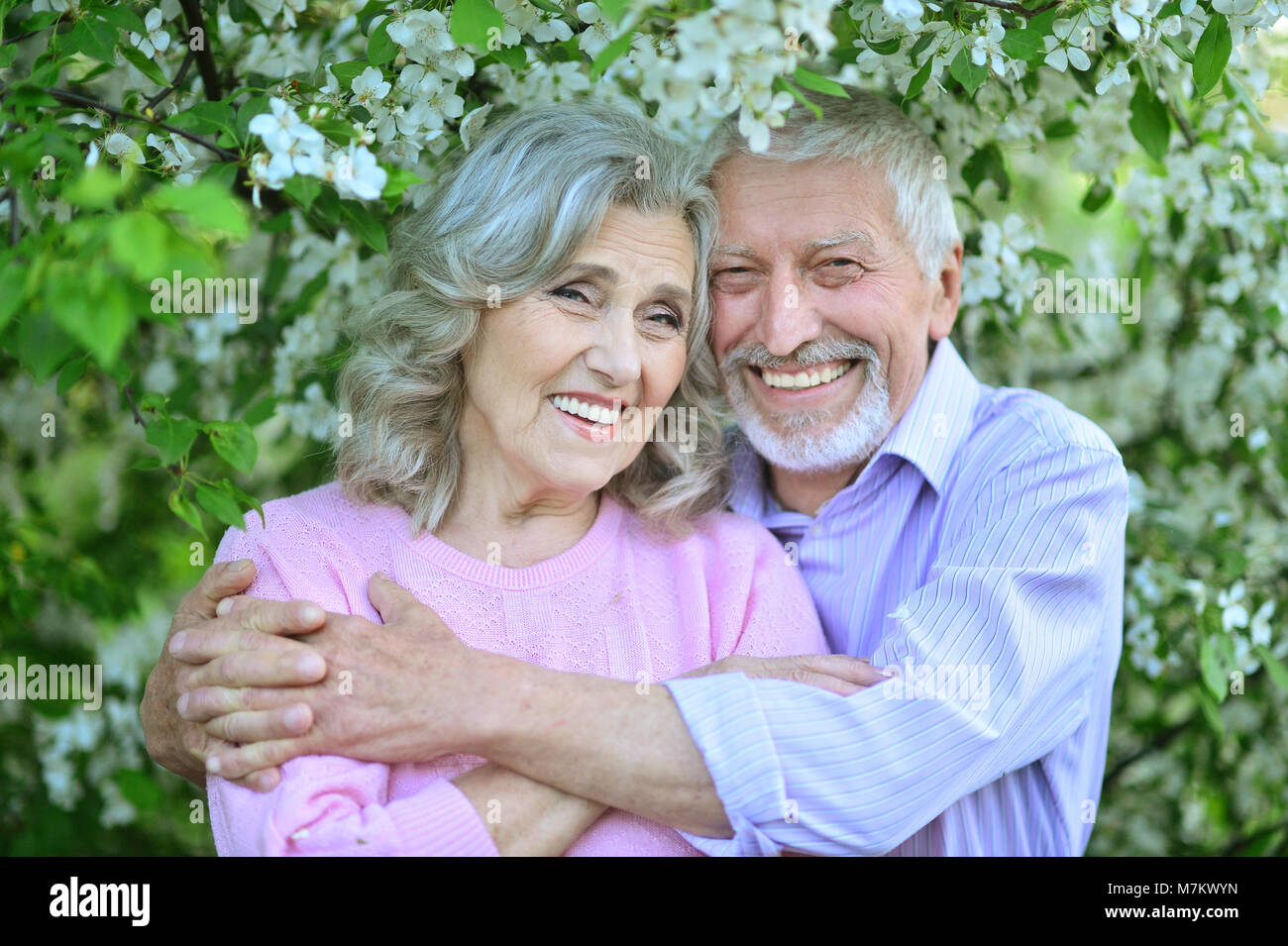 Happy couple hugging in spring park Stock Photo - Alamy