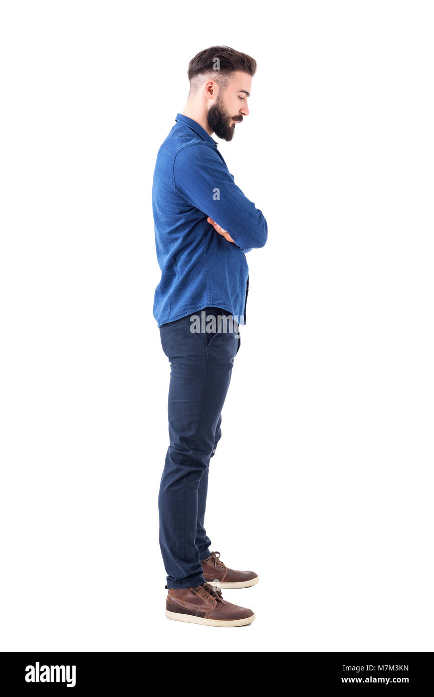 Profile view of sad man with bent down head and crossed arms looking down.  Full body isolated on white background Stock Photo - Alamy