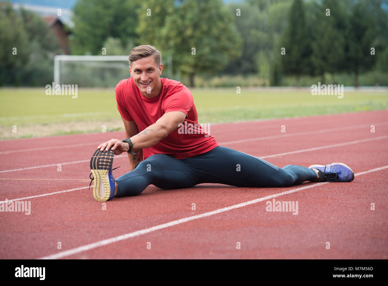 Portrait of Fit and Sporty Young Man Doing Stretching in the Park Stock ...
