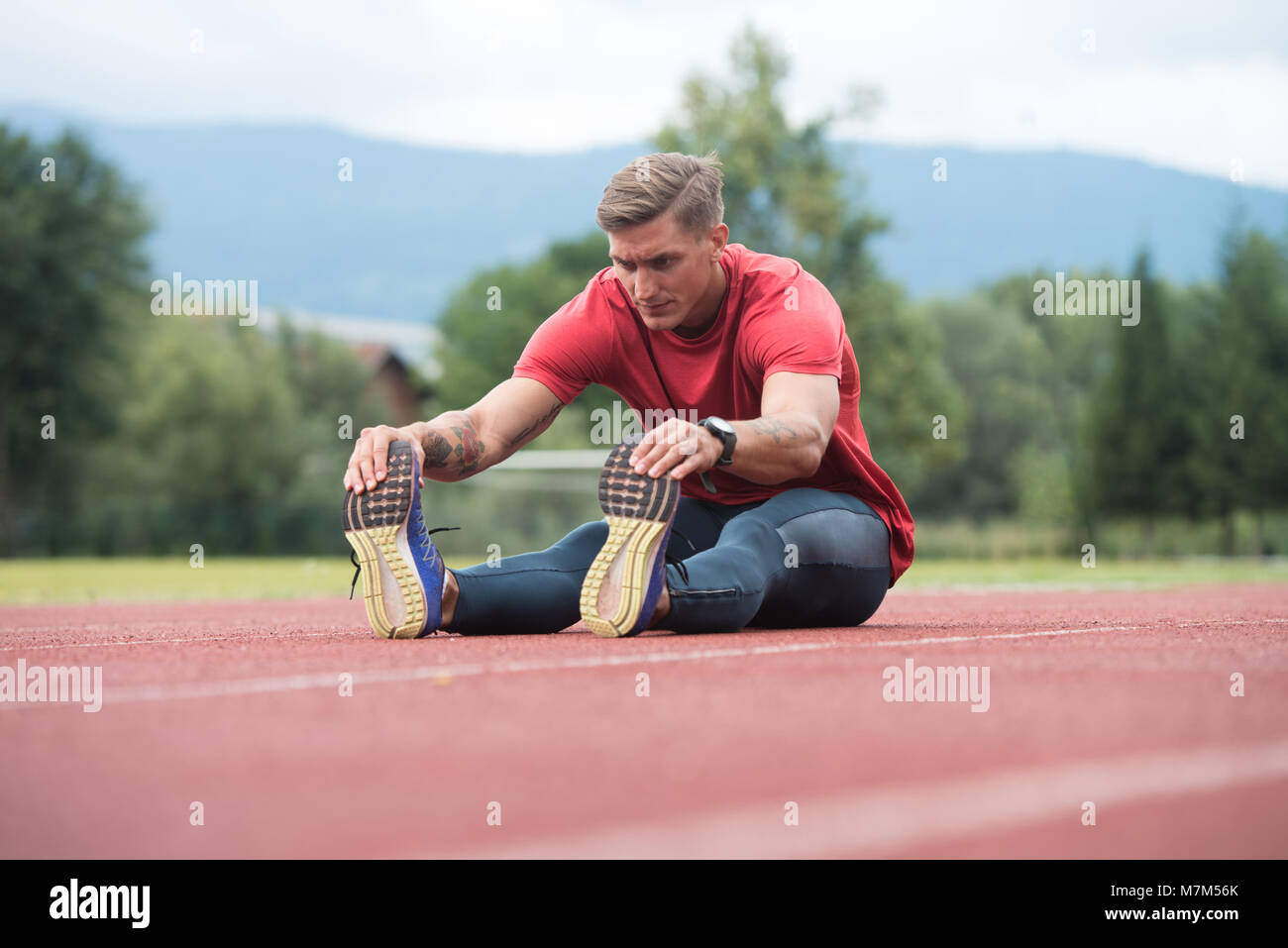 Portrait of Fit and Sporty Young Man Doing Stretching in the Park Stock ...