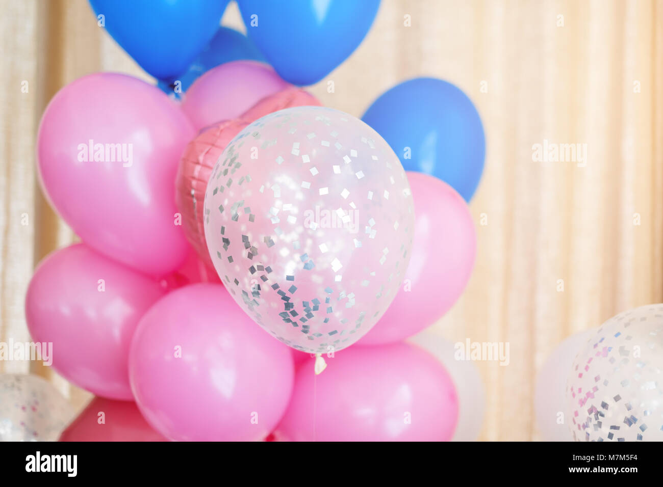 Pink, blue and white inflatable balloons. Decorations for birthday party Stock Photo