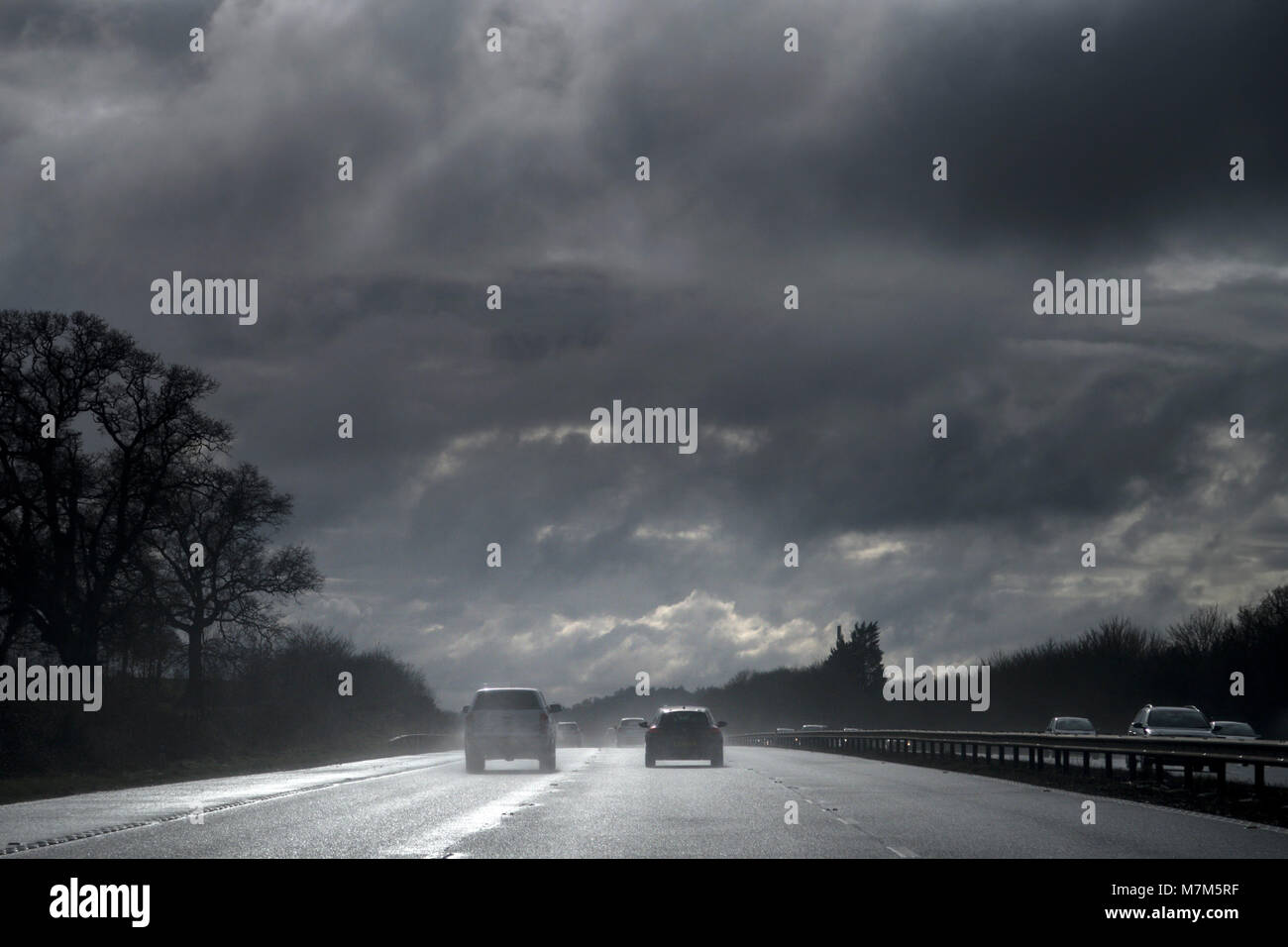 Spray from surface water on the M5 motorway creates poor visibility and dangerous driving conditions Stock Photo