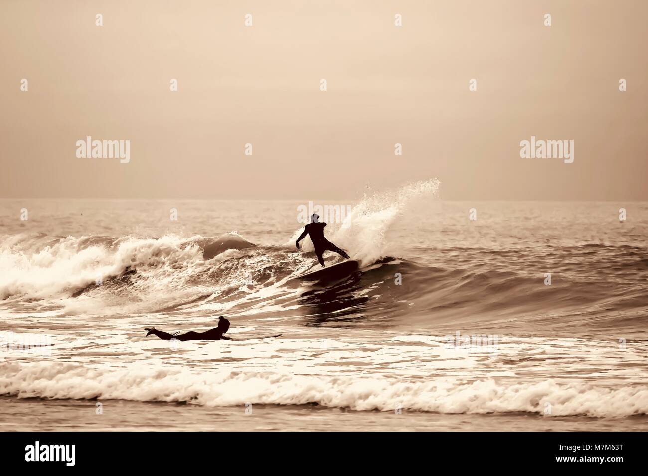 Sepia Tone Silhouette of Surfers Stock Photo