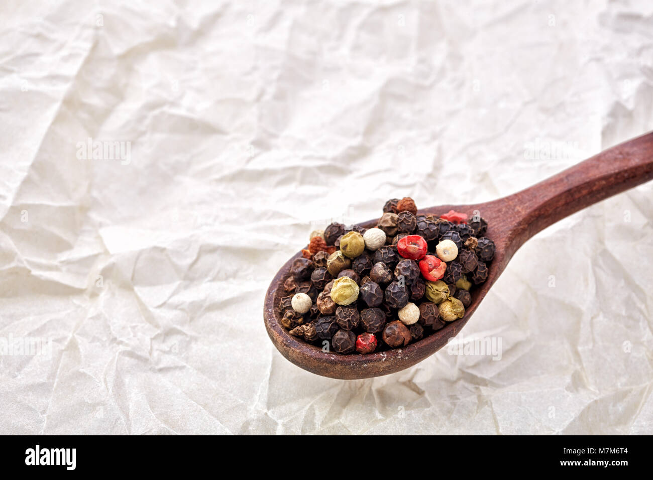 Closeup top view picture of red, white, yellow and black allspice