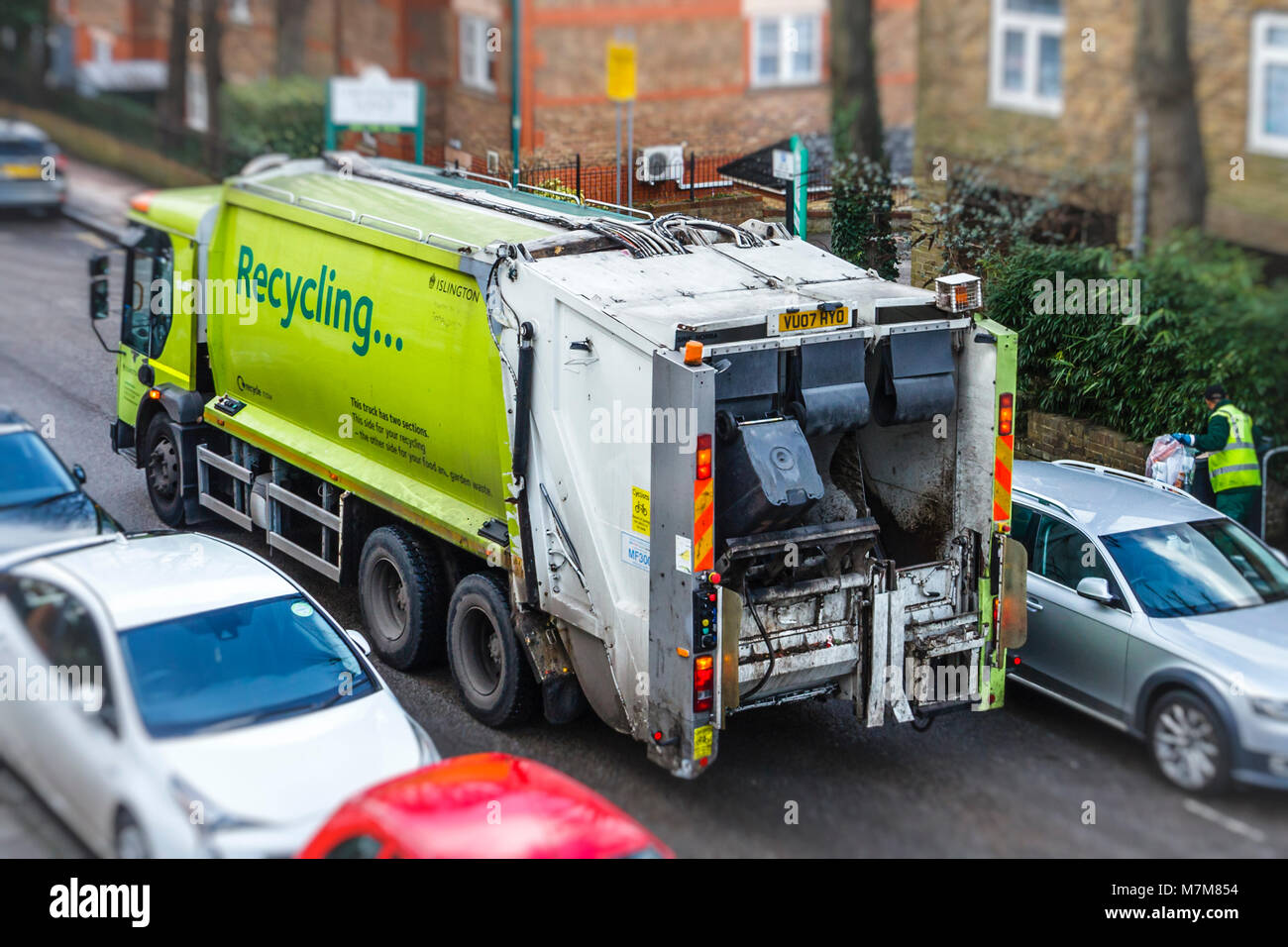 Recycling lorry making its weekly collection in a residential street in Islington, London, UK Stock Photo