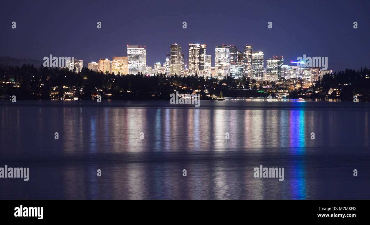 Fast growing Bellevue Washington city light reflecting in the water view from across the lake Stock Photo