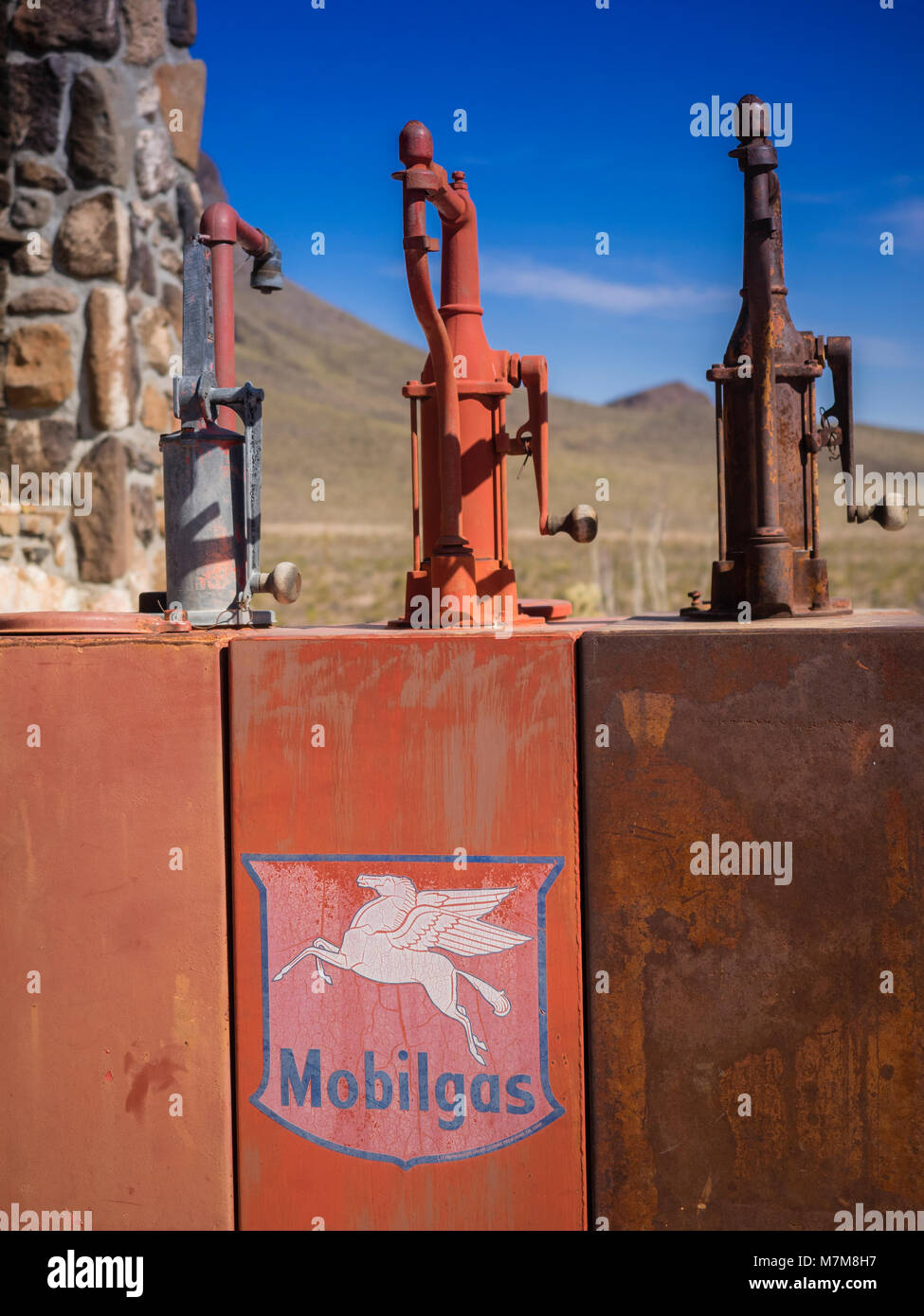 Three red antique metal oil tanks with pumps Stock Photo Alamy