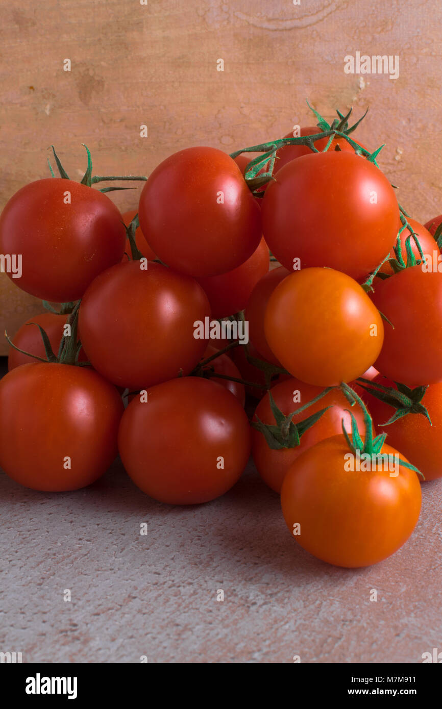 fresh bio red cherry tomatoes on the grey table Stock Photo - Alamy