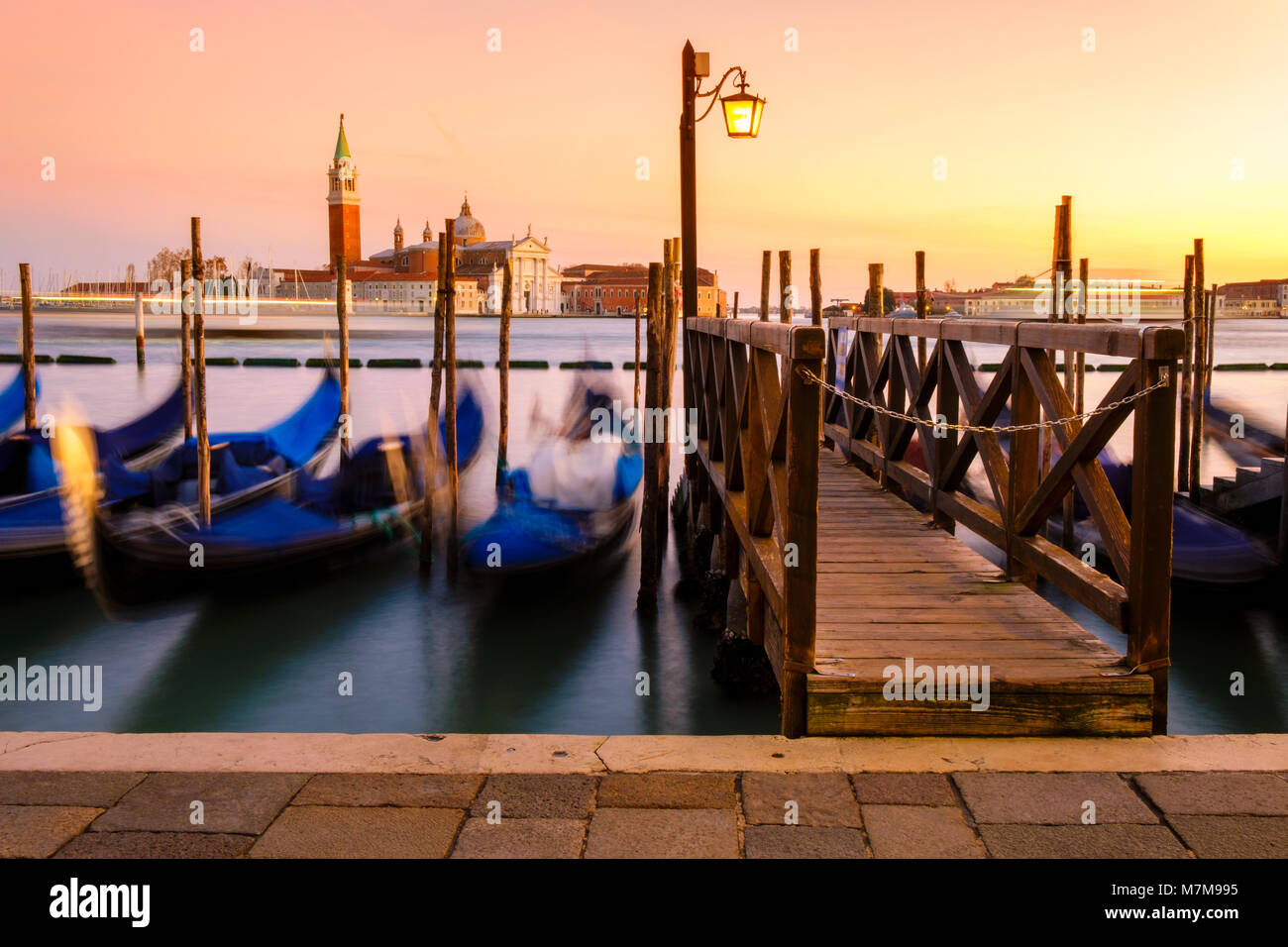 Venice with famous gondolas in lagoon at sunrise as a background can ...