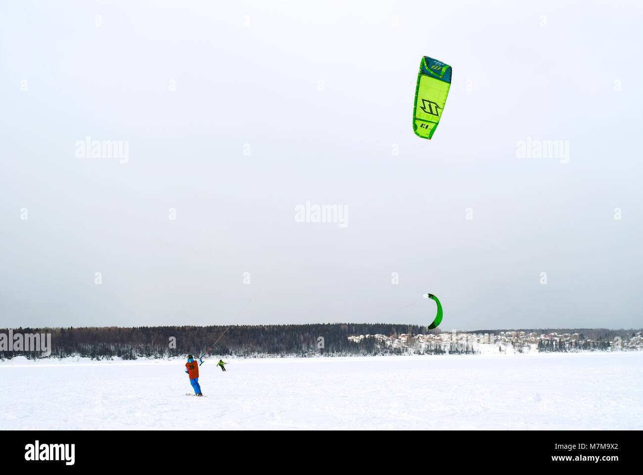 PERM, RUSSIA - MARCH 09, 2018: snow kiters rides on the ice of a frozen river Stock Photo