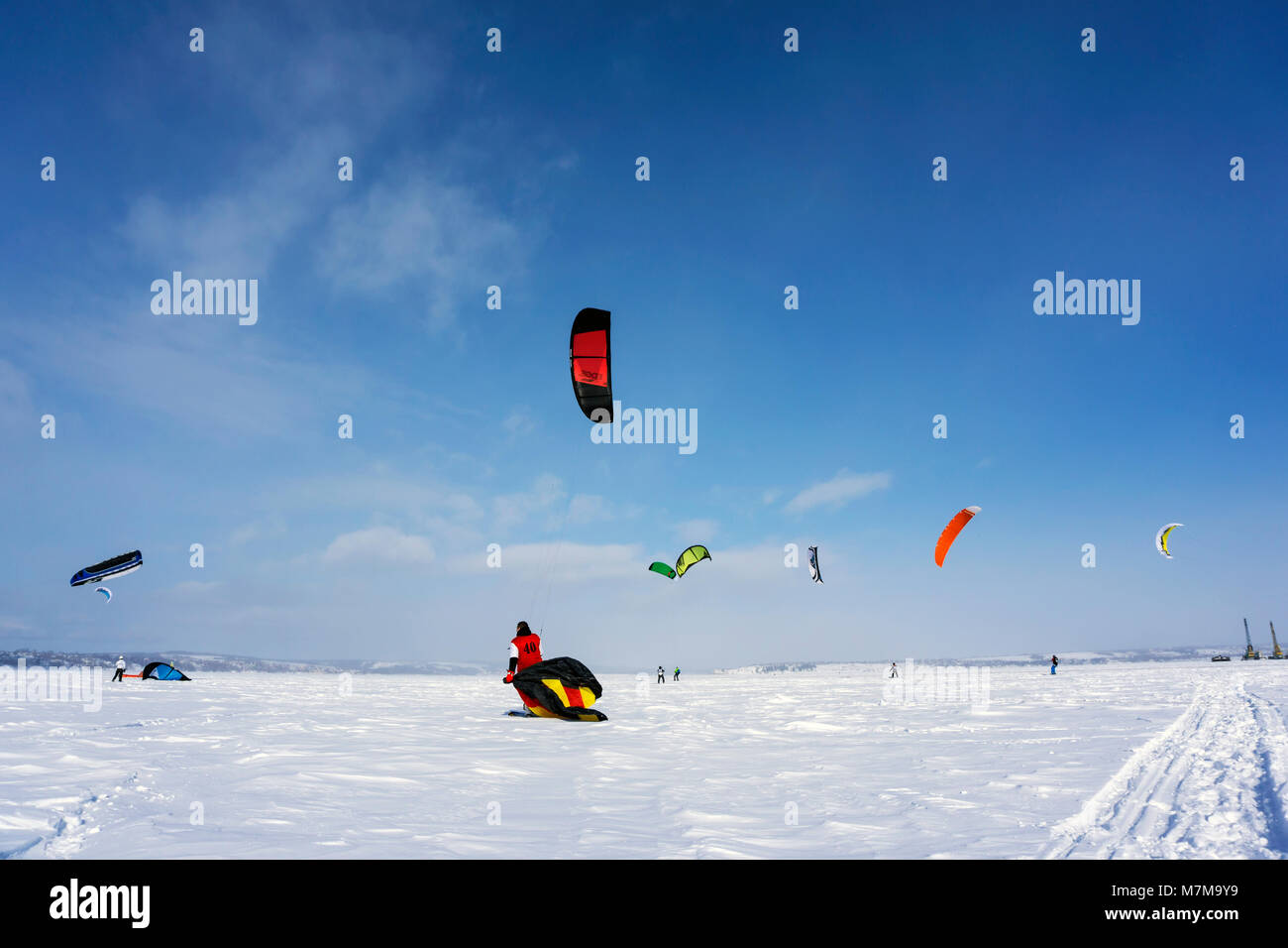 PERM, RUSSIA - MARCH 09, 2018: snow kiters rides on the ice of a frozen river Stock Photo