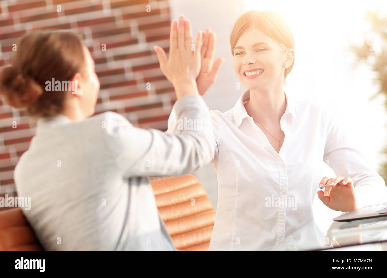 members of the business team giving each other a high five Stock Photo ...