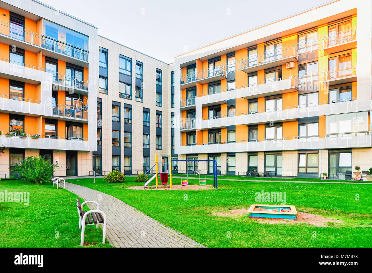 Complex of new apartment residential building with children playground ...