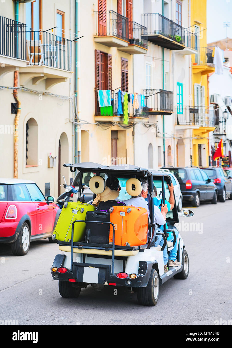 Golf cart with luggage bags in the street of Cefalu old town, Palermo region, Sicily island in Italy Stock Photo
