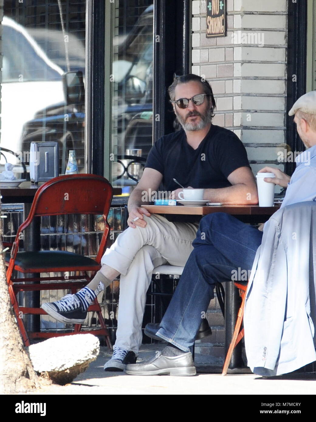 Actor Jaoquin Phoenix gets animated on a conversation with a friend while  having coffee at Little Dom's in Los Angeles. Featuring: Joaquin Phoenix  Where: Los Angeles, California, United States When: 09 Feb