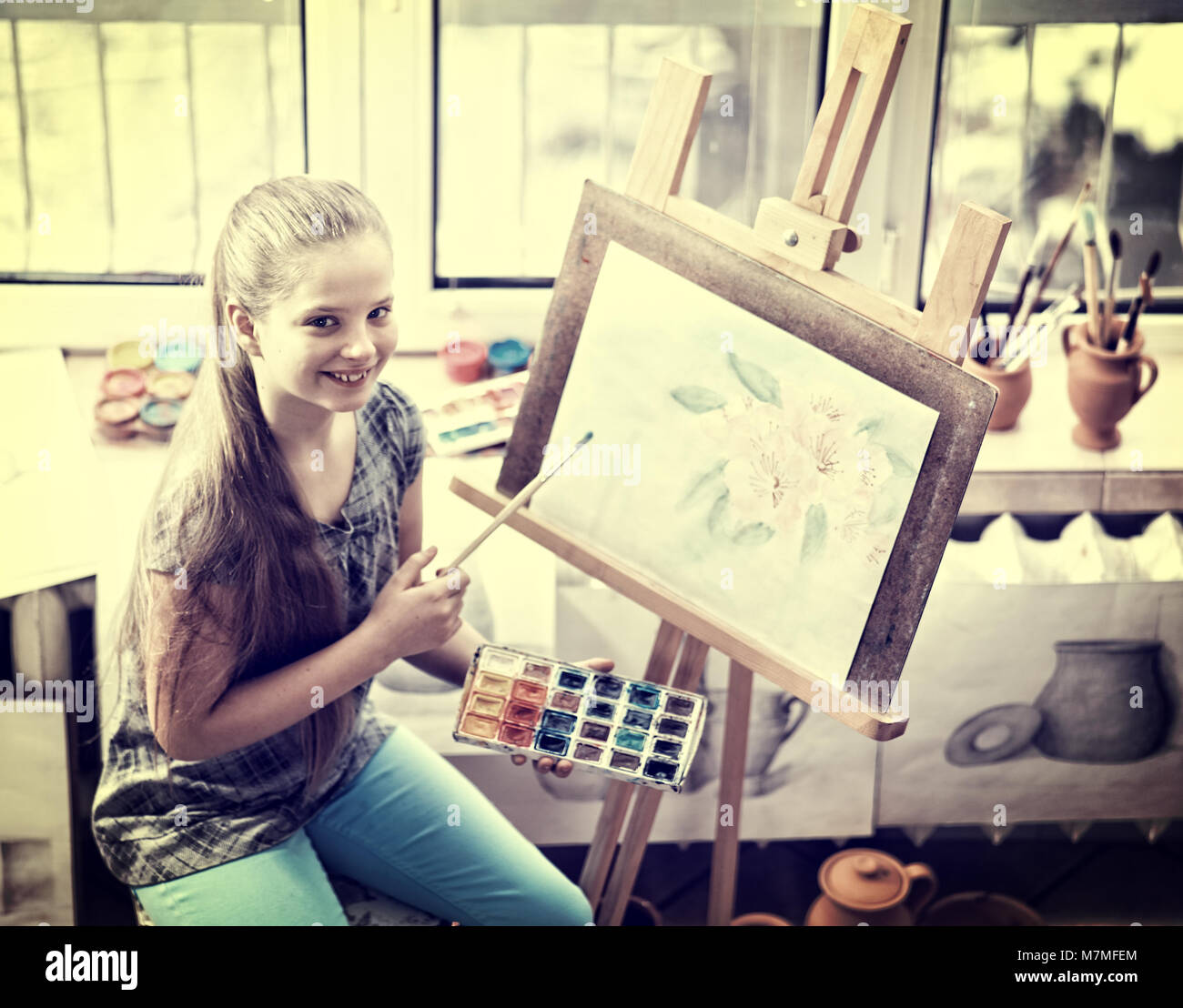 Artist painting on easel in studio. Girl paints with brush Stock Photo ...