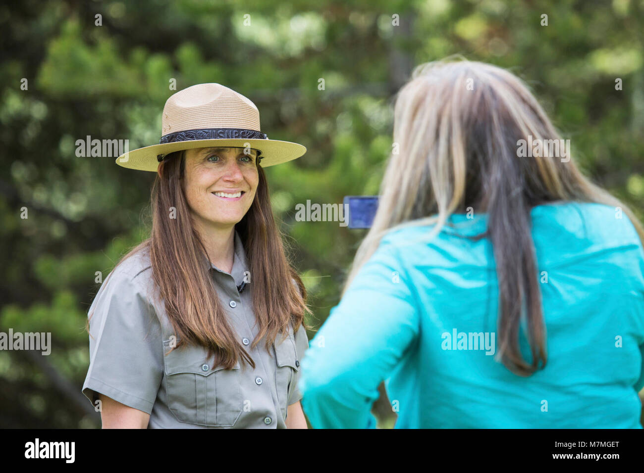 Public Information Officer being interviewed by a local reporter; June 2015; Stock Photo