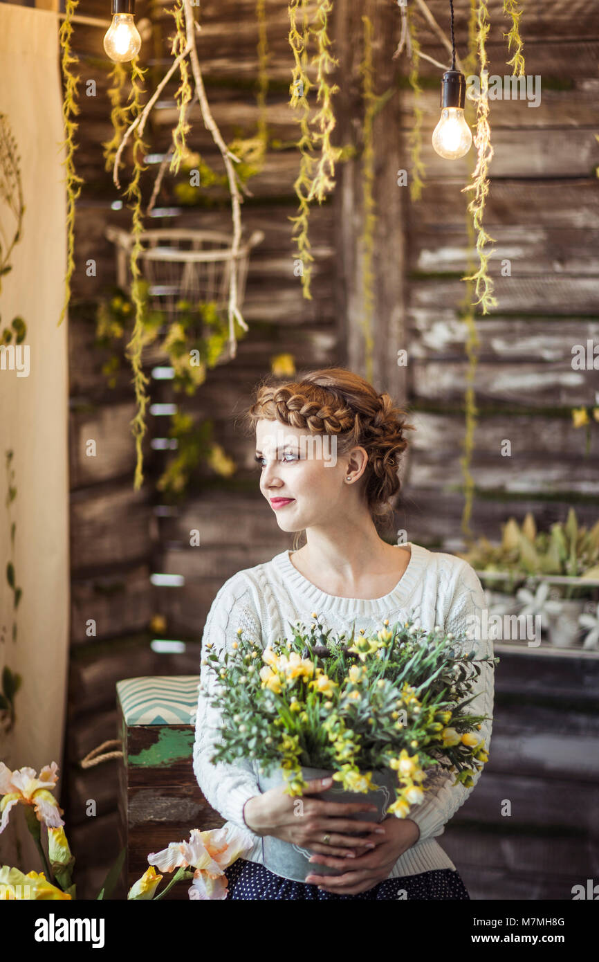 portrait of a beautiful happy young woman with a bouquet of flowers ...