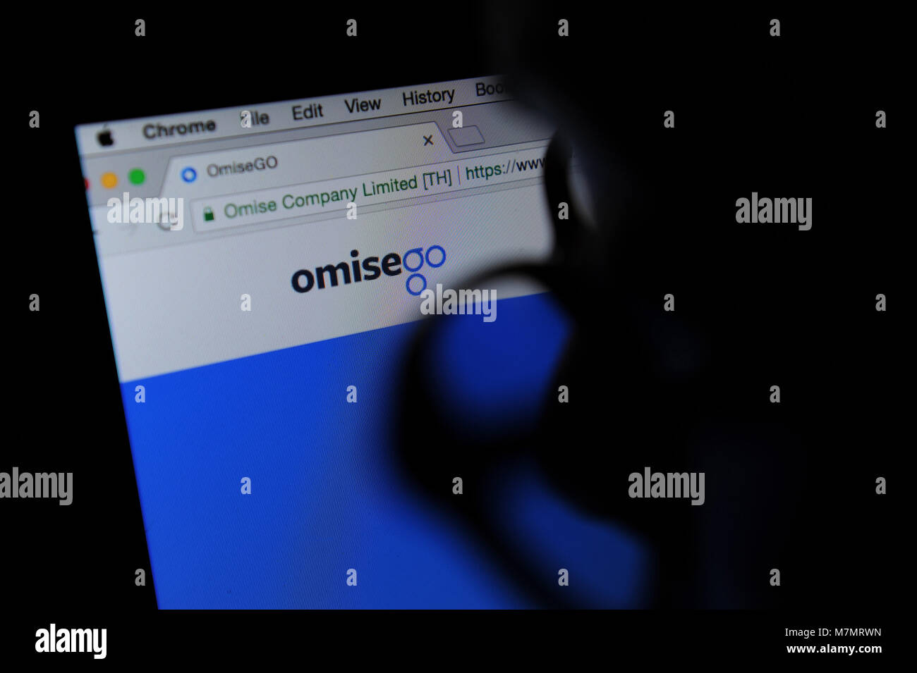 A person looks at the OmiseGO website Stock Photo