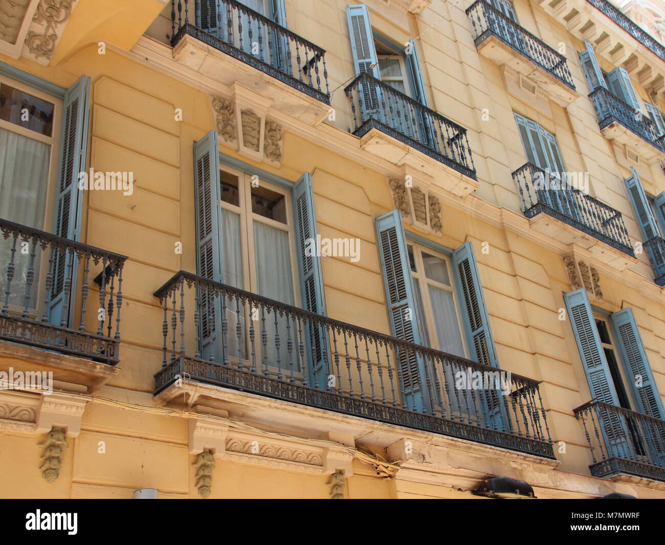Old Yellow Building Facade with Closed Wooden Window Shutters Stock ...