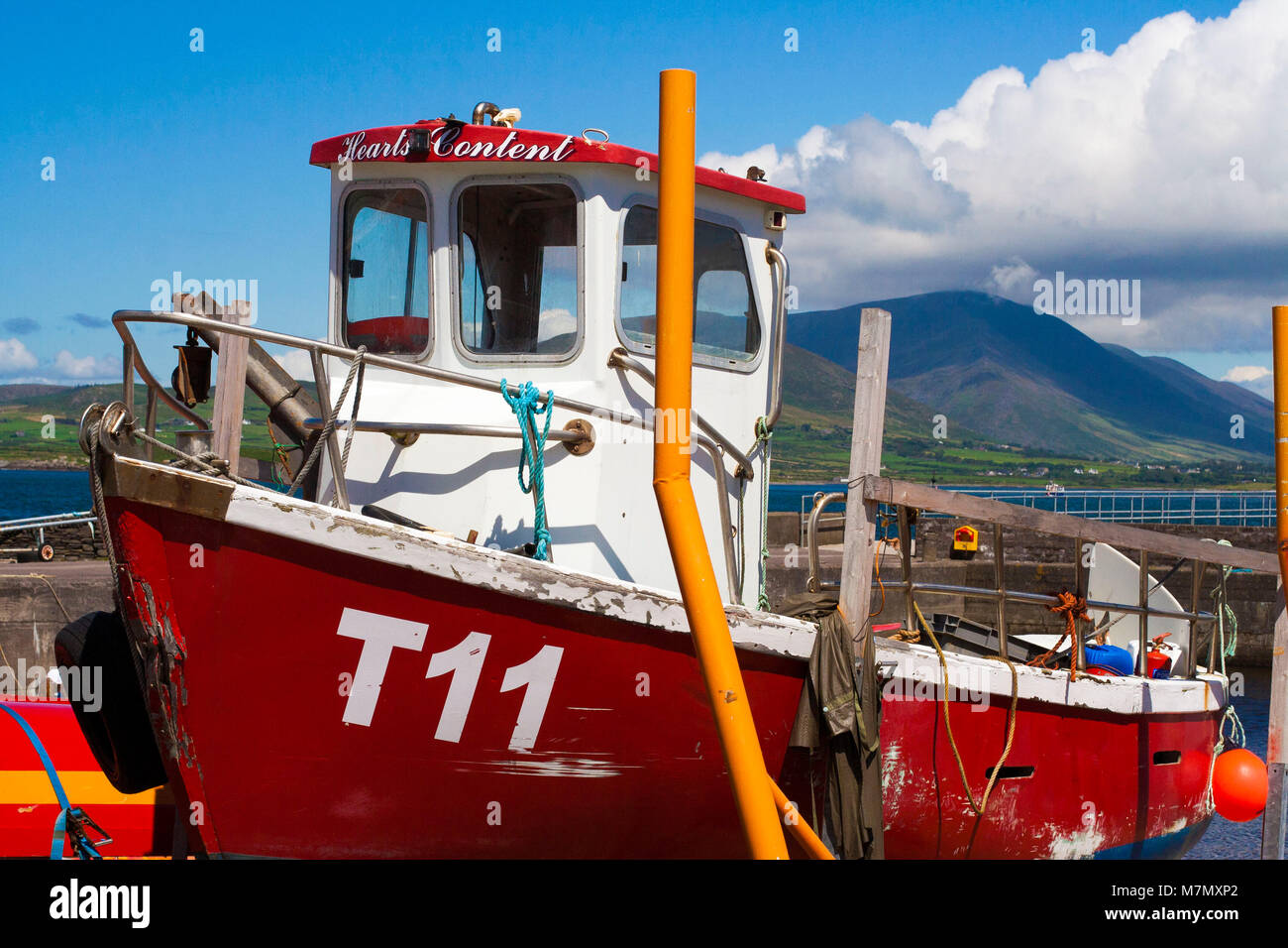 Closeup of a red white Fishing boat, vessel trawler docked in the harbour, Valentia Island Kerry Ireland Stock Photo