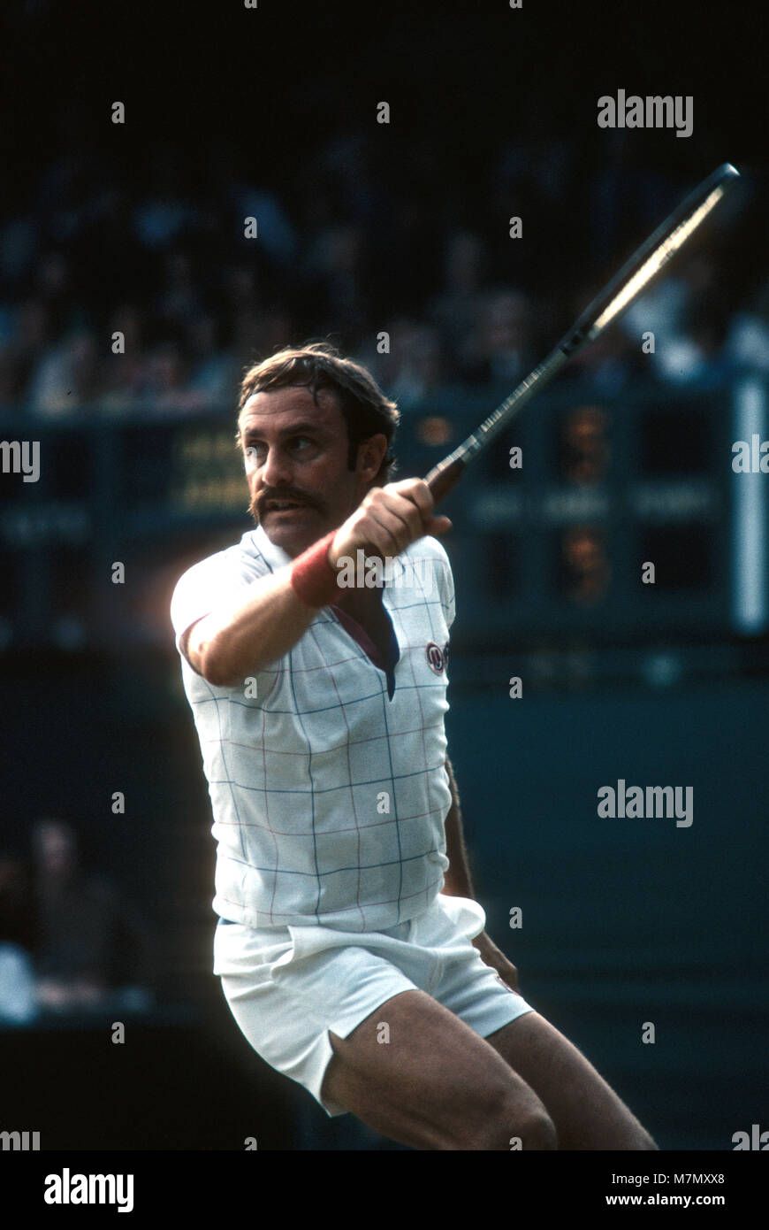 John Newcombe follows through on a backhand during match on court Number One at Wimbledon in 1979 Stock Photo