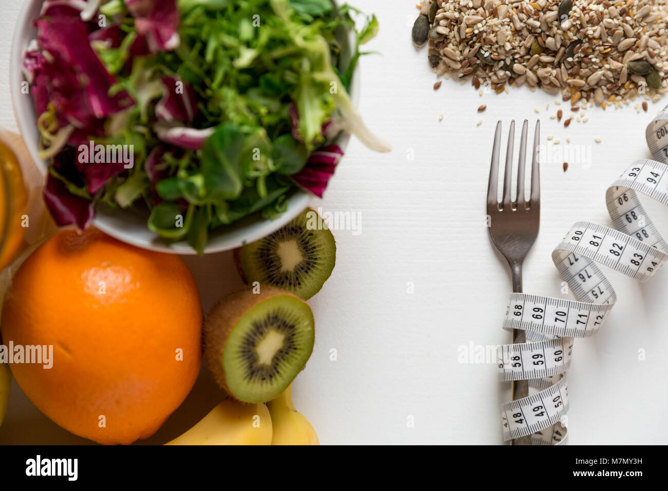 Healthy fruit,vegetables and measuring tape around the fork. Weight loss and right nutrition concept Stock Photo