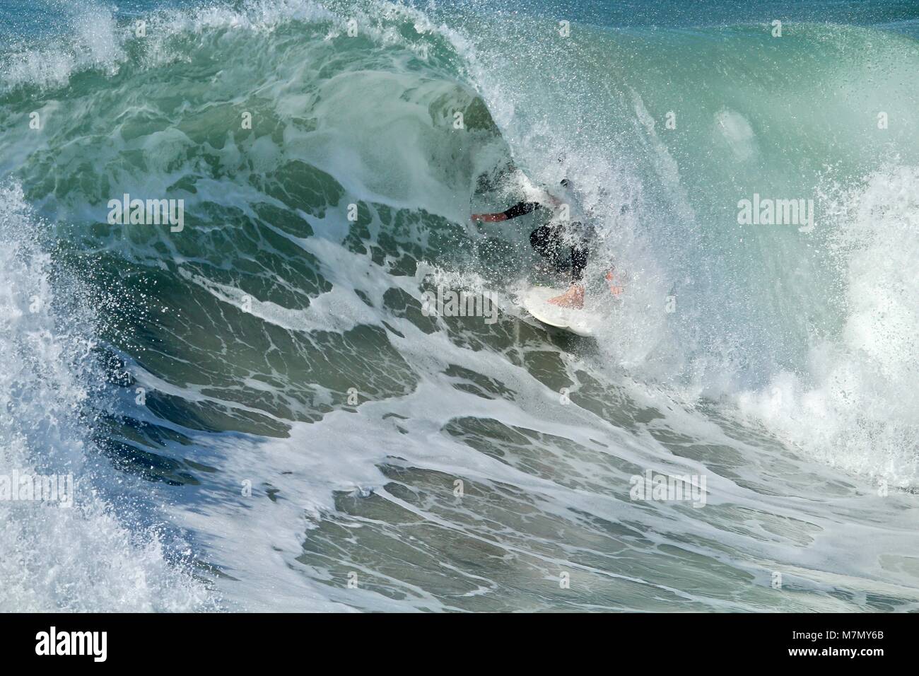 Surfer in the barrel of a wave Stock Photo