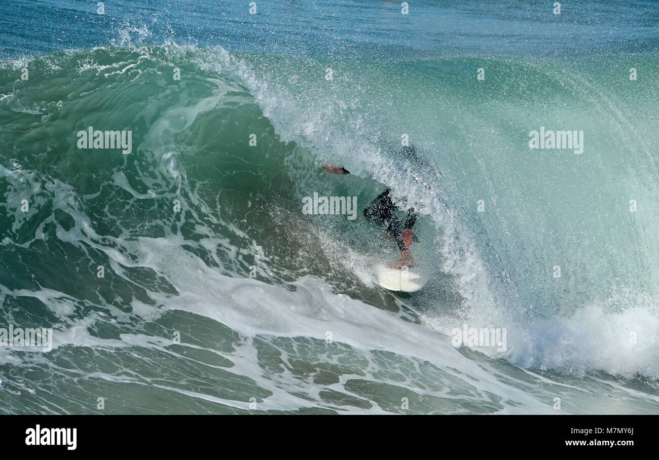 Surfer in the barrel of a wave Stock Photo