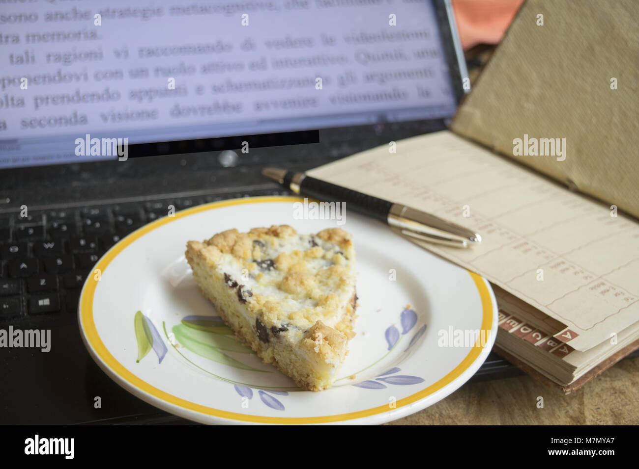 break work in office with a wedge of cream tart Stock Photo