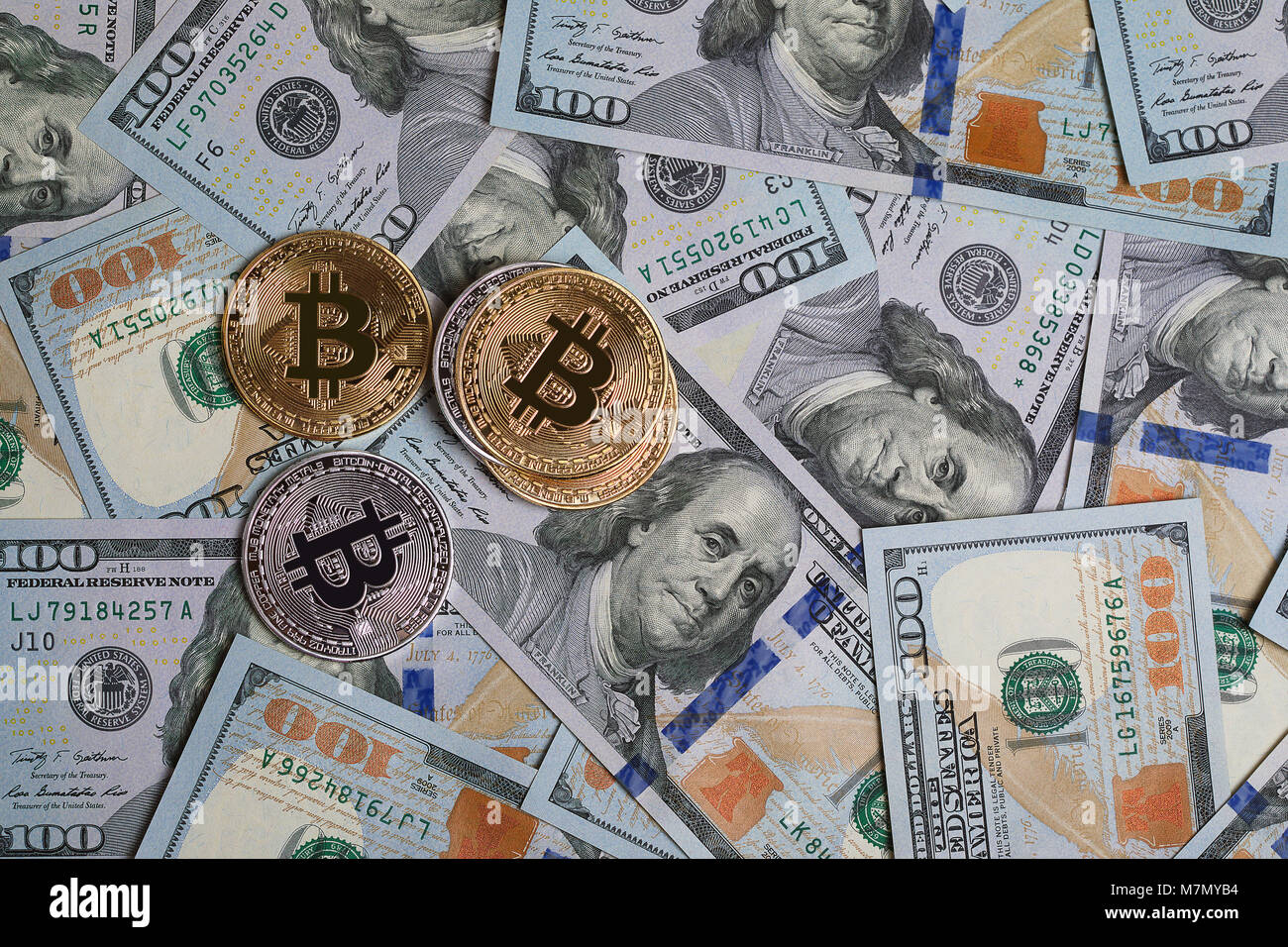 Golden and silver bitcoin on hundred dollars abstract background. Crypto- currency Stock Photo - Alamy
