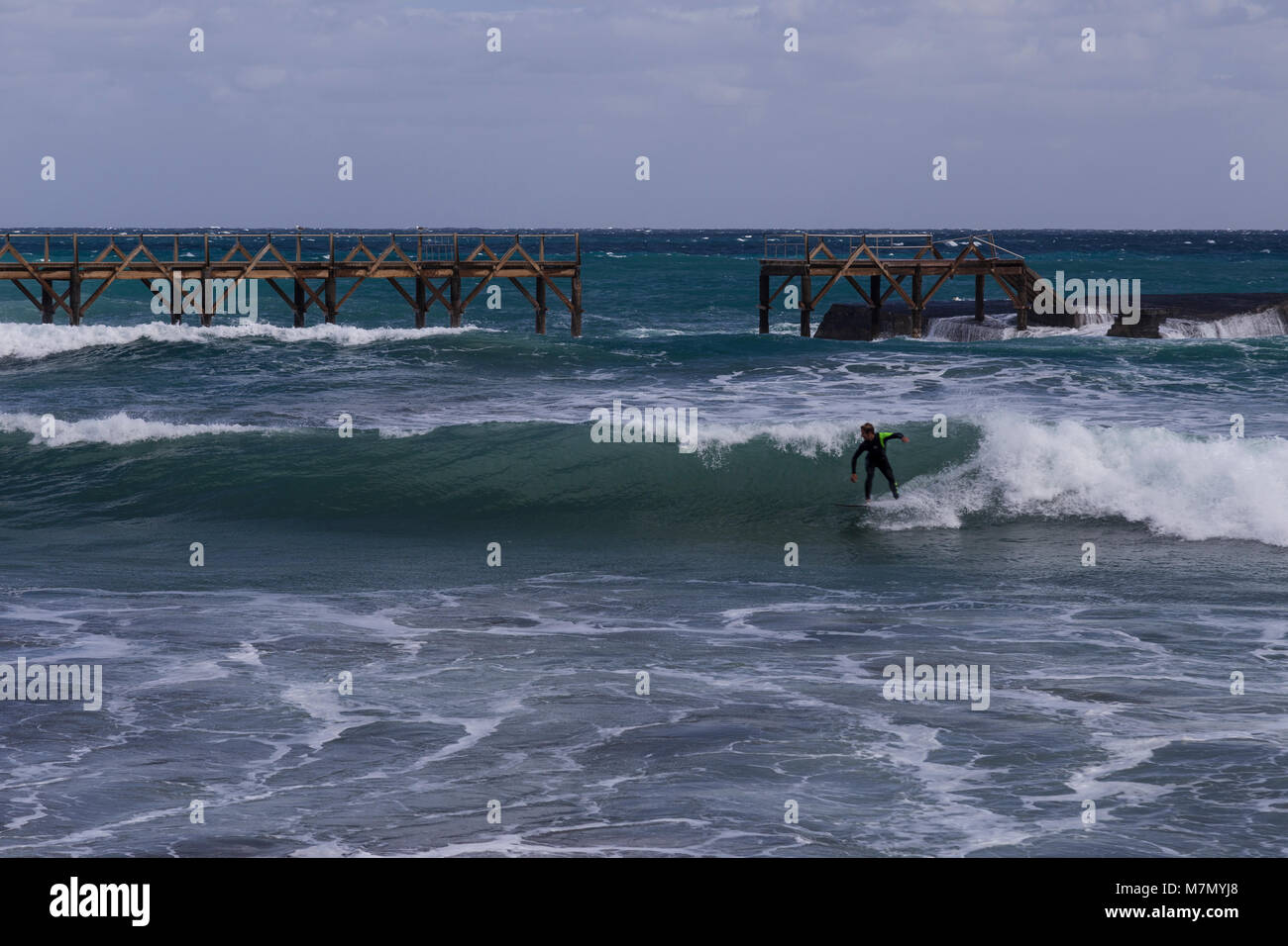 Surfer riding a wave at Arrieta, Lanzarote, Canary Islands Stock Photo