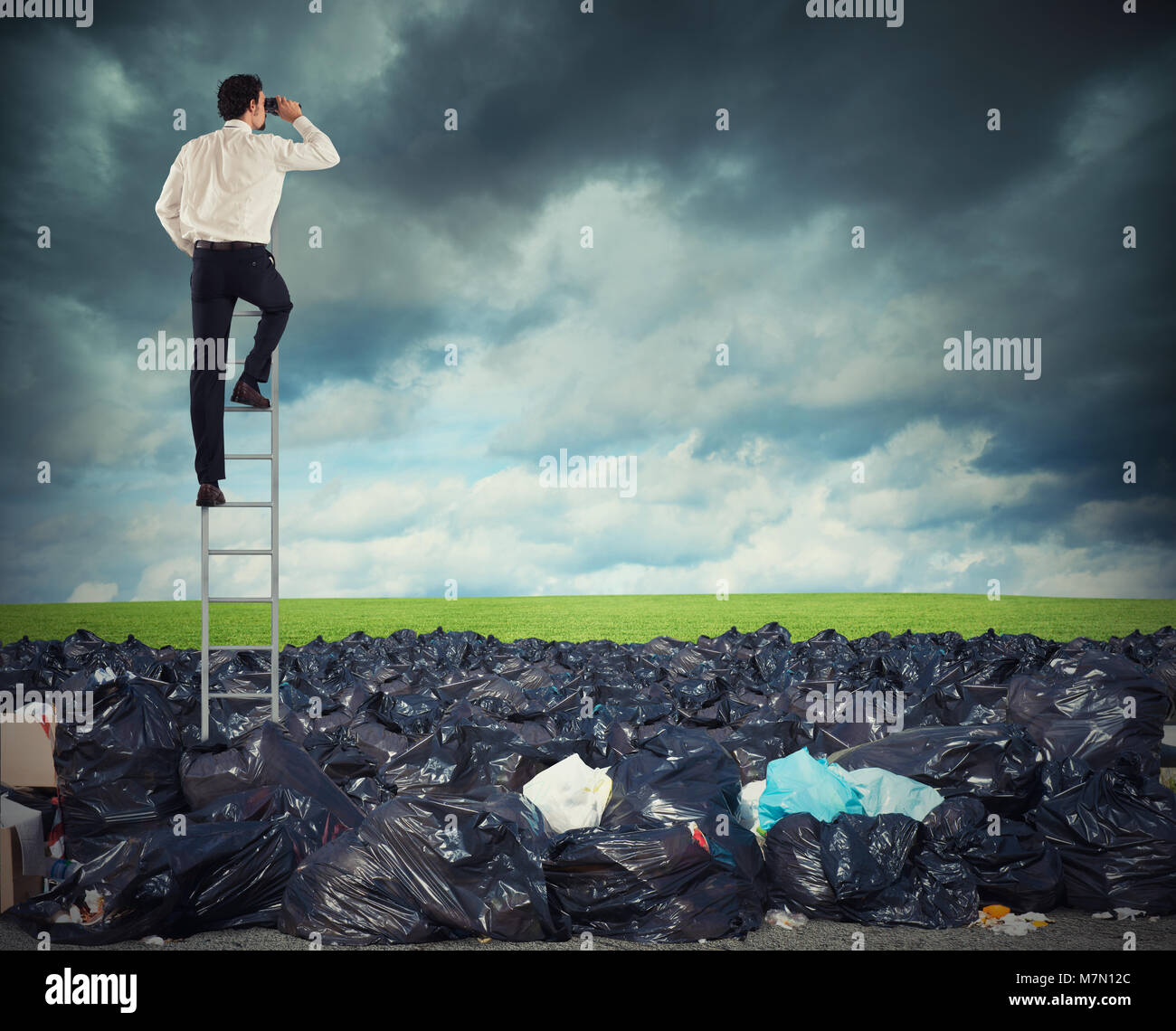 Businessman on a stairs searches far for clean environment. overcome the global pollution problem Stock Photo