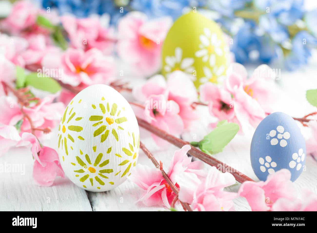 colorful easter eggs and branch with flowers Stock Photo - Alamy