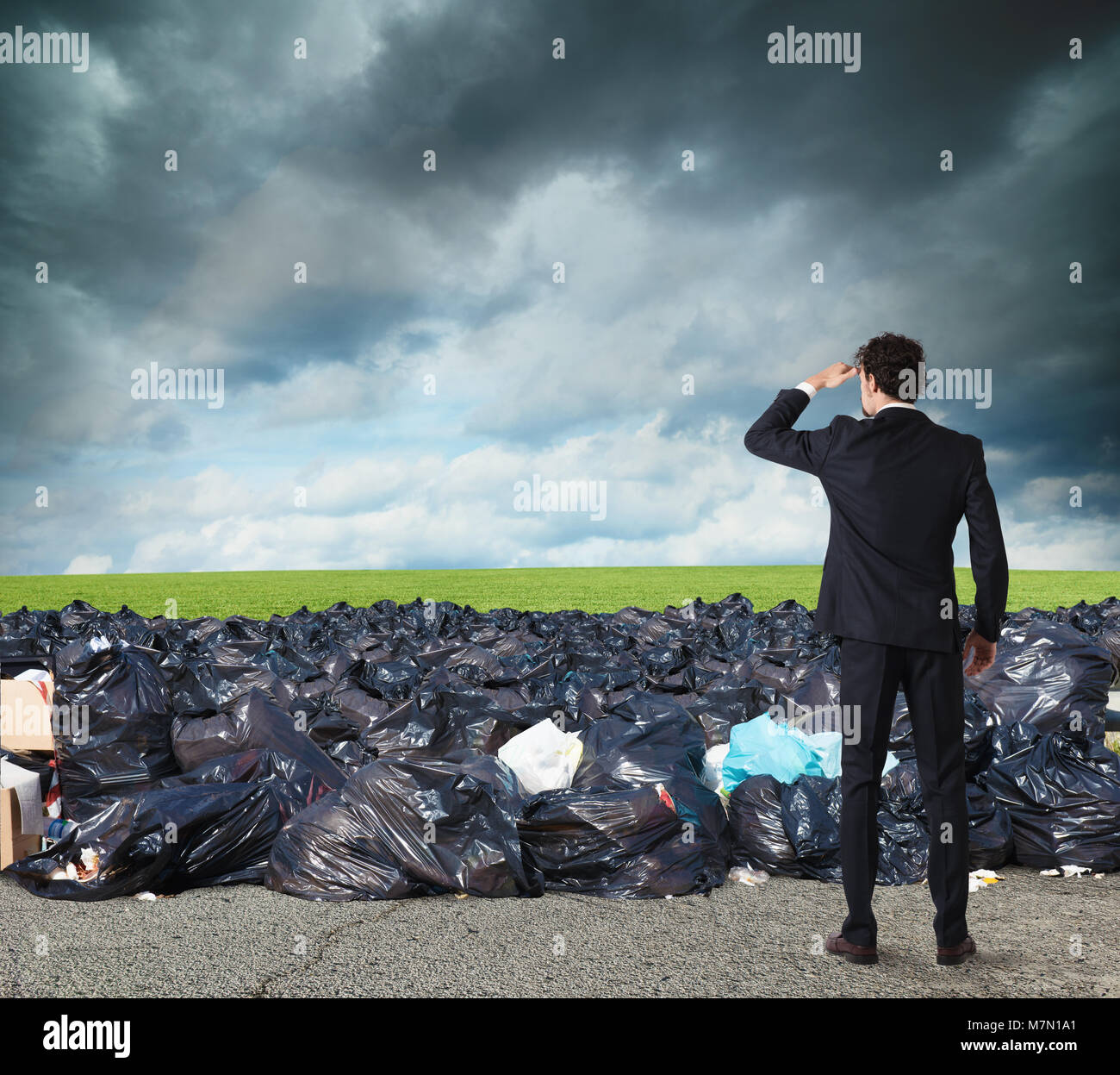 Businessman searches far for clean environment. overcome the global pollution problem Stock Photo