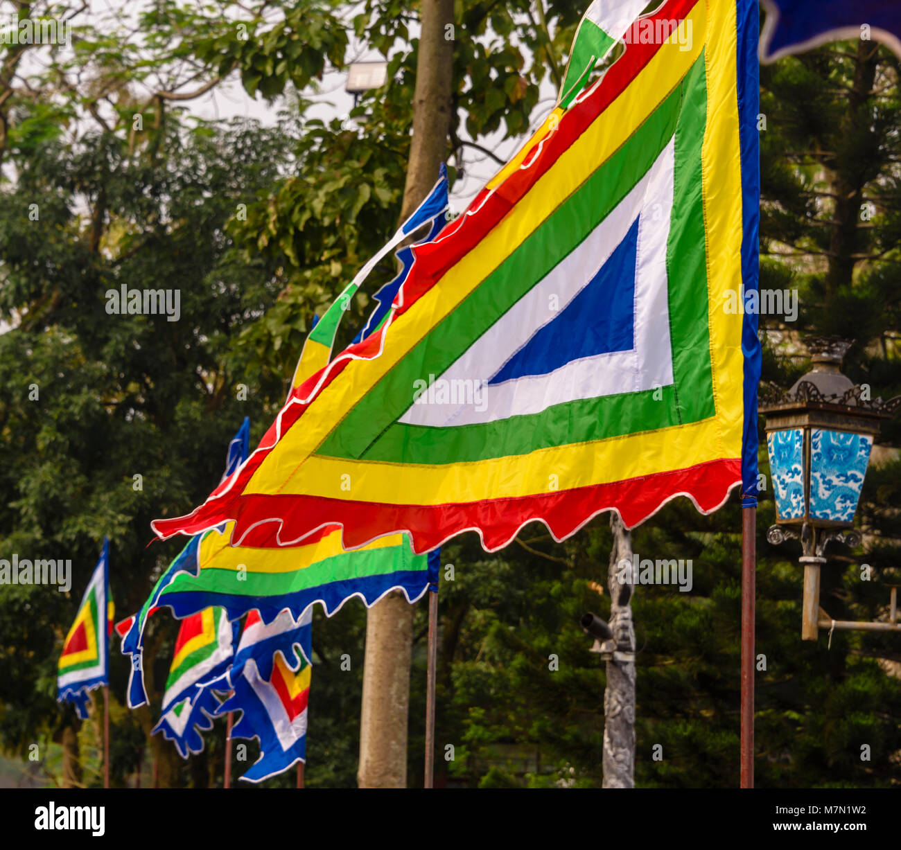 Multi-coloured trianguilar flags flying in Hue, Vietnam. Stock Photo