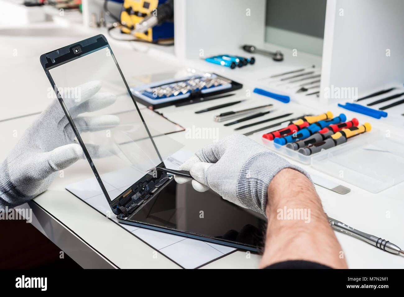 Close-up photos showing process of tablet device repair Stock Photo - Alamy