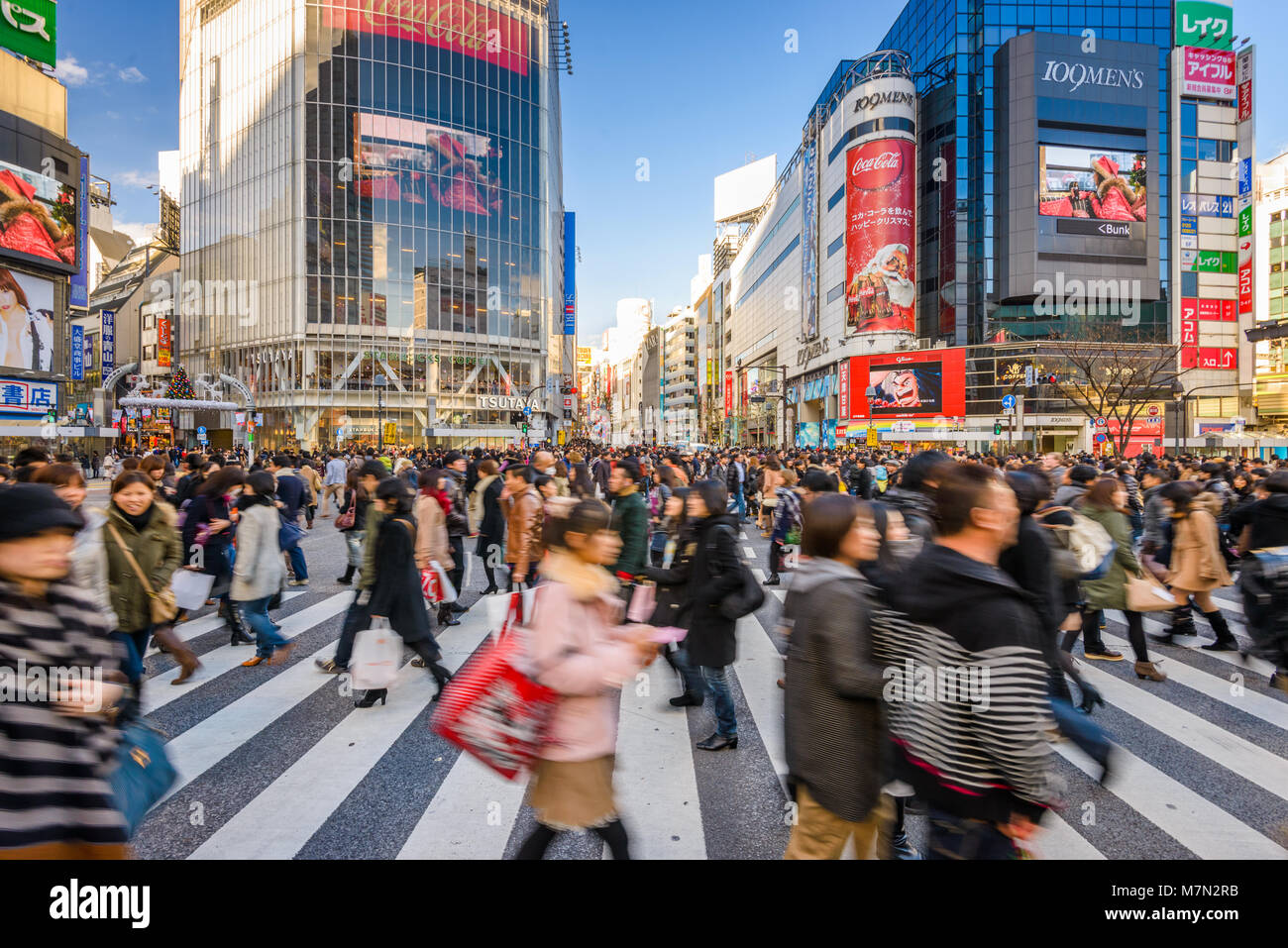 DECEMBER 24, 2012 - TOKYO, JAPAN: Pedestrians cross Shibuya Crossing, one of the busiest crosswalks in the world. Stock Photo