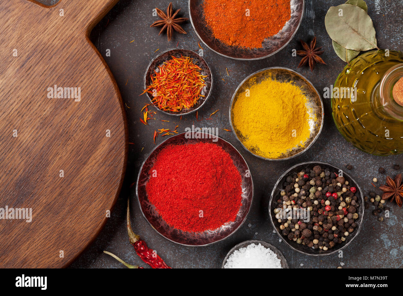 Colorful spices on stone table. Top view with space for your recipe ...