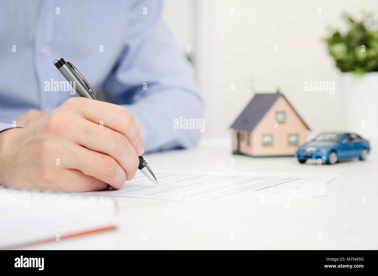 Insurance agent in office. Home and car safety care concept Stock Photo